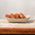 Eco-friendly corrugated disposable trays in a takeaway shop, perfect for delis, restaurants, and takeaways.