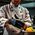 A chef wearing black nitrile gloves while preparing food in a commercial kitchen